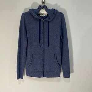 Sweater with hood, zip up, has pockets.